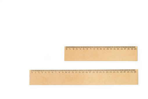Two wooden rulers on a white background with copy space