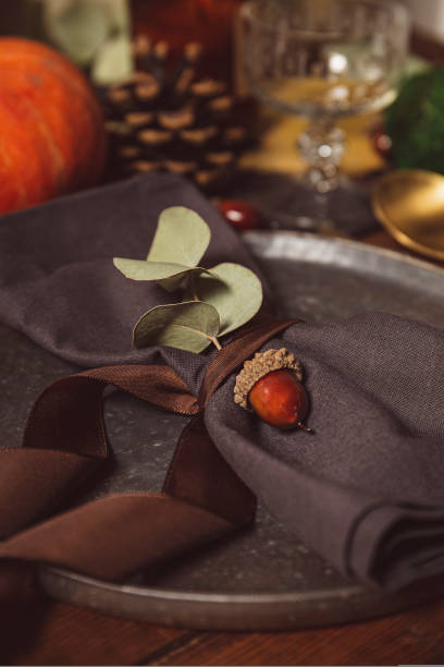 istock Served table with autumn decor. Thanksgiving dinner table setting close up vertical photo 1436458373