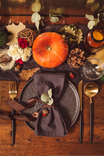 istock Served table with autumn decor. Thanksgiving dinner table setting, vertical photo top view 1436458956