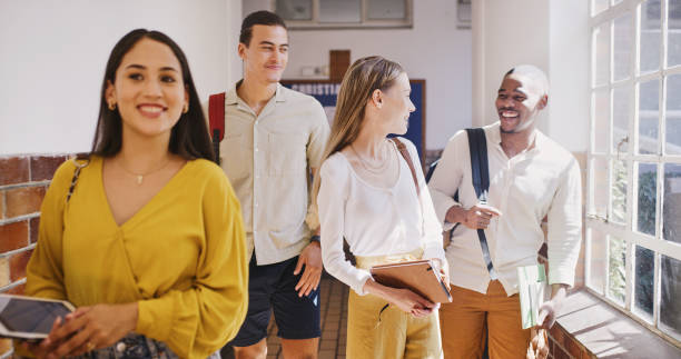 istock Walking, university and friends talking about education, project and learning scholarship in the hallway to class at school. Happy and young students in communication about group to study at college 1436459481