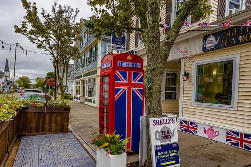 Plymouth, Massachusetts, USA - September 12, 2022: British style telephone booth on downtown sidewalk.