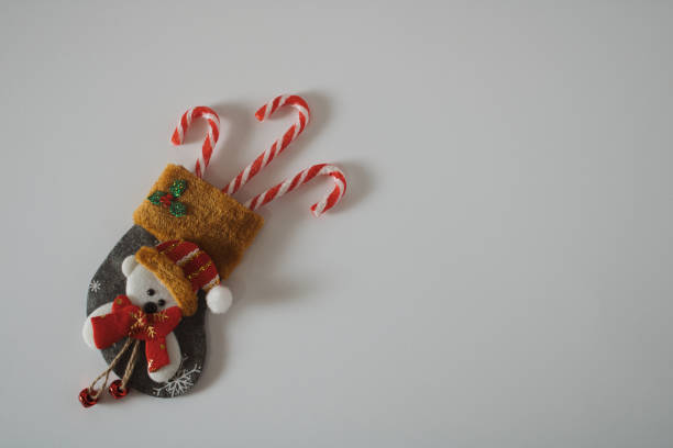 istock Canvas boot decorated with teddy bear filled with red and white Christmas sweets by Santa 1436460871