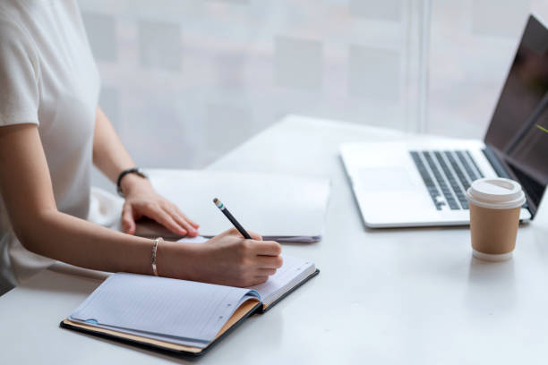 istock Image of a businesswoman holding a pen and taking notes on work concept. 1436462771