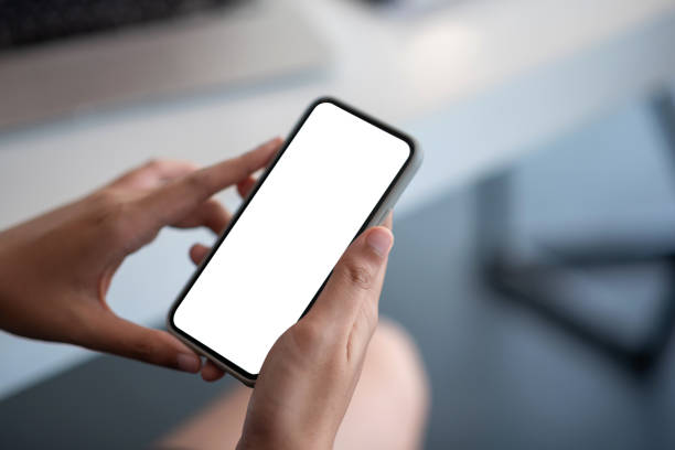 istock Woman holding a smartphone blank white screen at the office. 1436462942