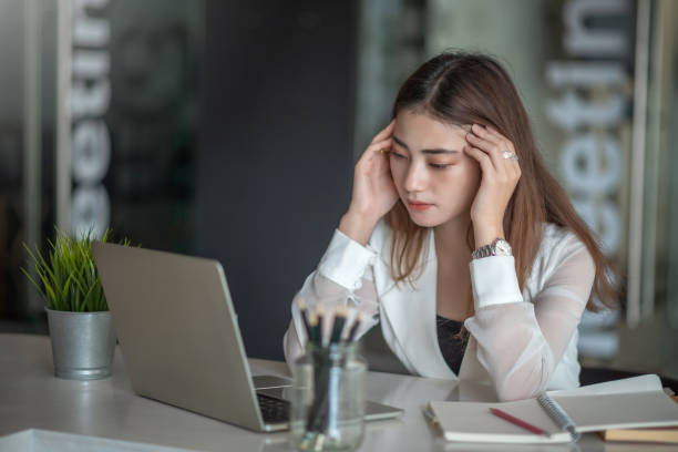 young asian business woman feeling sick and tired or exhausted from office work. - failure relationship difficulties computer women imagens e fotografias de stock