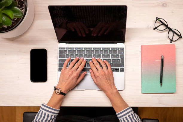istock High angle view of a woman typing on laptop computer 1436463133