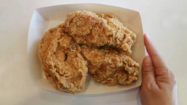 fried chicken, deep fried chicken in the paper dish stock photo