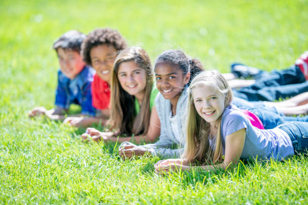 istock Children Laying in the Grass Portrait 1436465467
