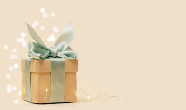 istock Gift box with bow and christmas lights background 1436469725