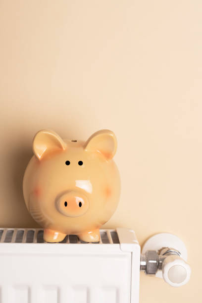 istock Piggy bank  sit on a radiator 1436471040