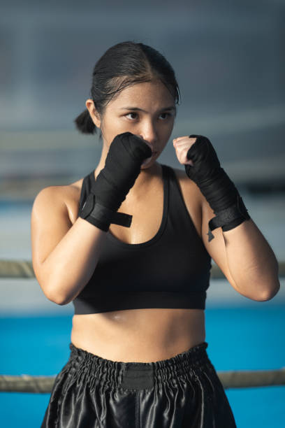 istock Young Asian Female MMA Fighter Posing 1436471885
