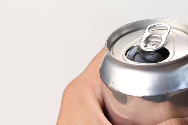 istock Person holding an open aluminum can on white background. 1436472383