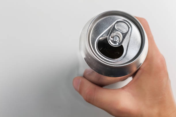 istock Person holding an open aluminum can on white background. 1436472444