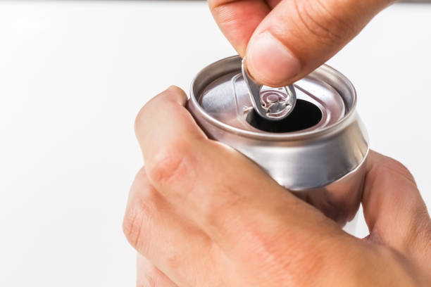 istock Person opening an open aluminum can on white background. 1436472470