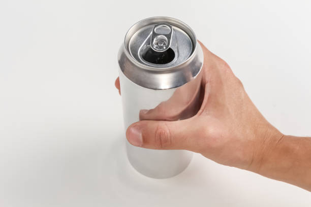 istock Person holding an open aluminum can on white background. 1436472471