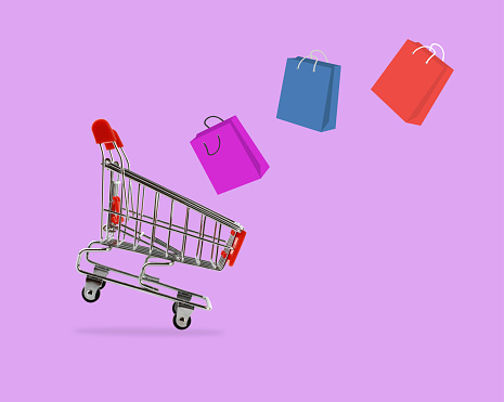 Shopping cart with shopping bags  on purple background, Sale and shopping concept