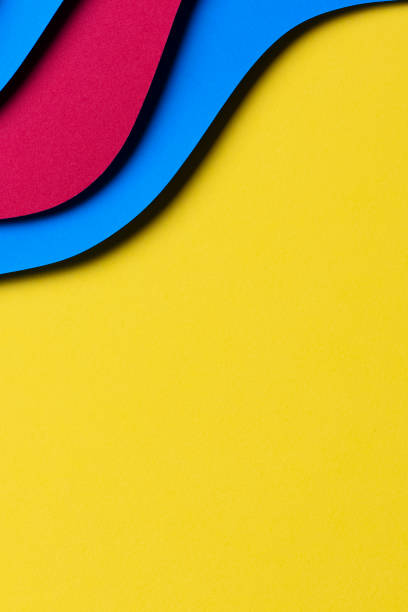 istock Abstract colored paper texture background. Minimal paper cut style composition with layers of geometric shapes and lines in red and light blue colors on yellow background. Top view 1436479034