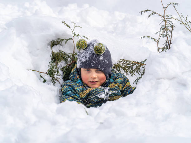 istock Happy baby boy playing in the snow 1436481970
