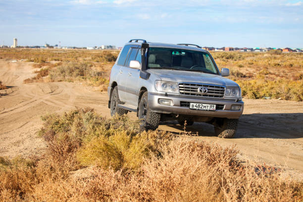 Atyrau, Kazakhstan - October 18, 2022: Grey offroad car Toyota Land Cruiser 100 in the steppe.