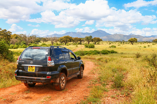 Taita Hills, Kenya - February 3, 2021: Black offroad car Toyota Land Cruiser Prado 120 in the Tsavo West National Park.