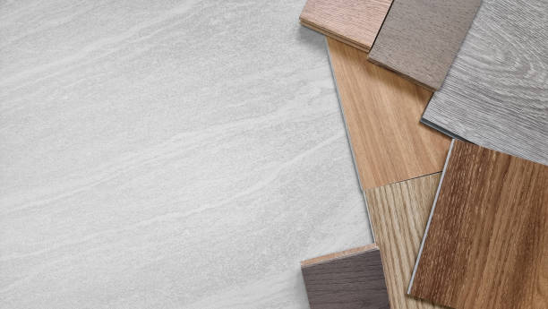 istock samples of interior material, wood, on travertine marble table with blank space. interior design selected material including various type of engineering and vinyl flooring tiles for construction. 1436483255