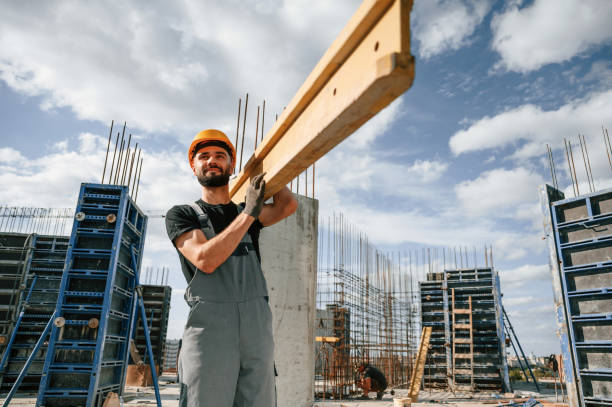 istock Front view. Carrying wooden plank. Man in uniform is working on the construction site 1436483650