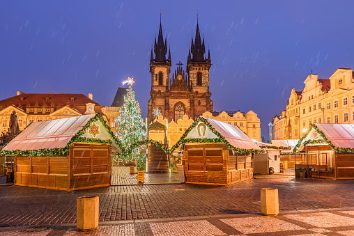 Christmas market in Prague Capital decorated with light and traditional decorations outdoors, in front of the cultural Cathedral in Czeck Republic - Europe