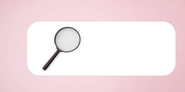 istock Magnifying glass on awhite and pink background. Like a search. 1436484015