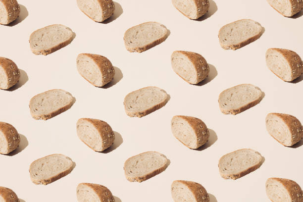 istock Slices of bread on a cream background. Pattern. 1436484120