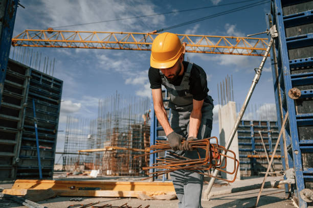 istock Working with rusty metal pieces. Man in uniform is on the construction site 1436484122