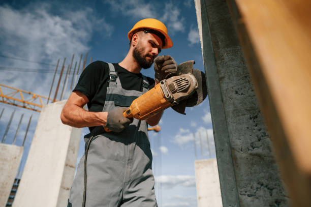 istock Holding grinding machine. Man in uniform is working on the construction site 1436484841