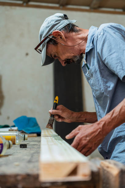 istock older adult man carpenter by profession is in his carpentry working 1436487459