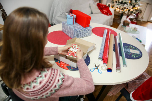 istock Young woman packing gifts 1436489811