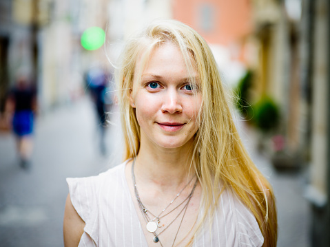 Portrait of young blonde woman outdoors