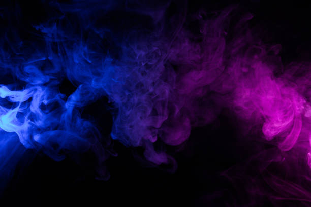 Clouds of colorful swirling blue and pink smoke stock photo