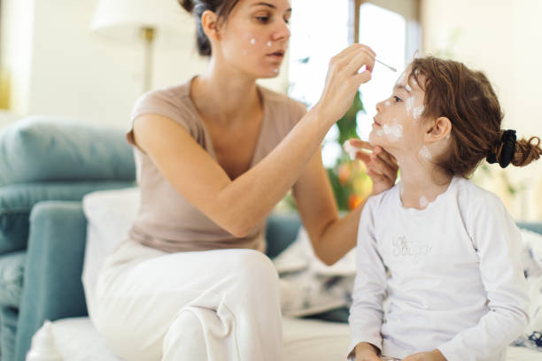 istock Girl with chickenpox at last stage sitting at home in quarantine 1436493321