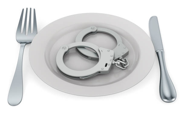 Plate with handcuffs, 3D rendering Plate with handcuffs, 3D rendering isolated on white background prison meal stock pictures, royalty-free photos & images