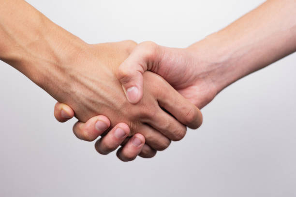 istock strong male handshake with bare hands on a white background 1436496933
