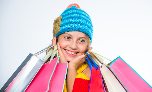 Shopping on black friday. Girl amazed face knitted hat hold shopping bags white background. Amazing shopping concept. Buy clothes amazing discount. Get promo code. Amazing sale and discount.