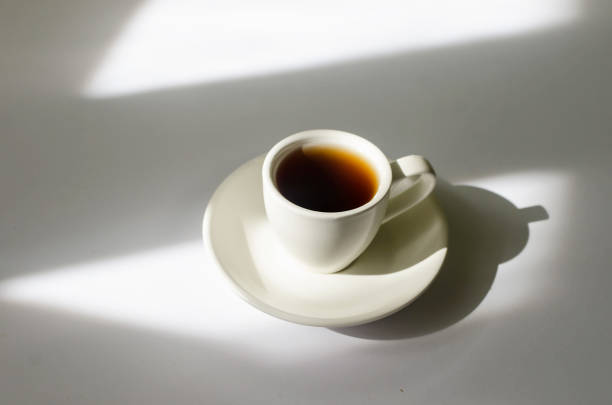 istock A cup of hot coffee in the morning sunlight  on white table. 1436498092