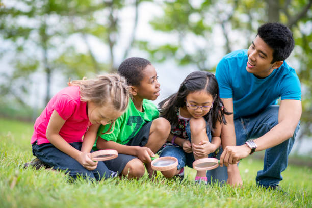 istock Day Camp Counselor Exploring with Children 1436498795