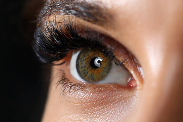 istock Beautiful female green colored right eye with eyelashes extensions 1436499745