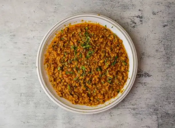 Photo of chicken qeema served in a plate isolated on background top view of indian and pakistani desi food