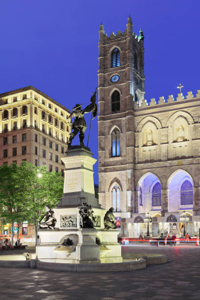 Montreal old town cityscape featuring Place d’Armes, the Maisonneuve monument ( c.1895 by Louis-Philipp Hebert ) and Notre-Dame basilica (Quebec, Canada).