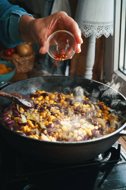 Preparing Burrito Butternut Squash Boats Preparing Burrito Butternut Squash Boats Filled with Ground Beef, Corn and Kidney Beans squash soup stock pictures, royalty-free photos & images