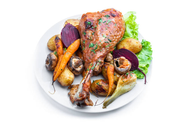 istock Oven roasted turkey and vegetables with spices and herbs isolated on white 1436503400
