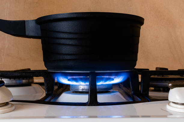 istock Black metal pot on gas stove 1436503521