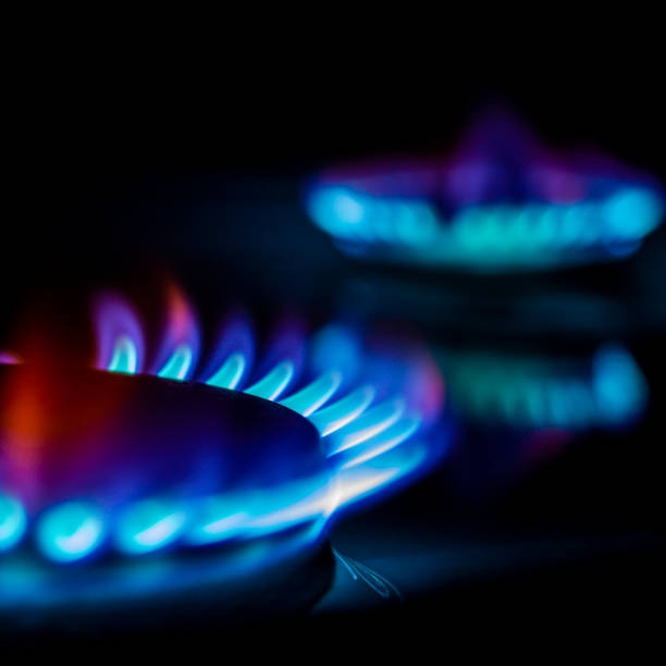istock a hundred dollar bill on a gas burner with a burning fire on a black background, the front and back background is blurred with a bokeh effect 1436503836