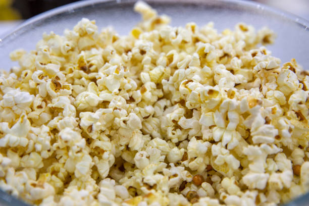 istock popped popcorn in a glass bowl top view closeup 1436505448