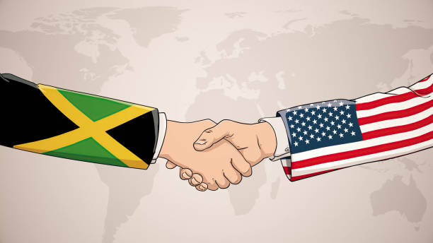bildbanksillustrationer, clip art samt tecknat material och ikoner med cooperation between jamaica and usa in front of world map. the concept of america, handshake, business agreement, politics, meeting, country flags, celebrate, international friendship relations, diplomats shaking hands, peace trade policy - welcome to jamaica